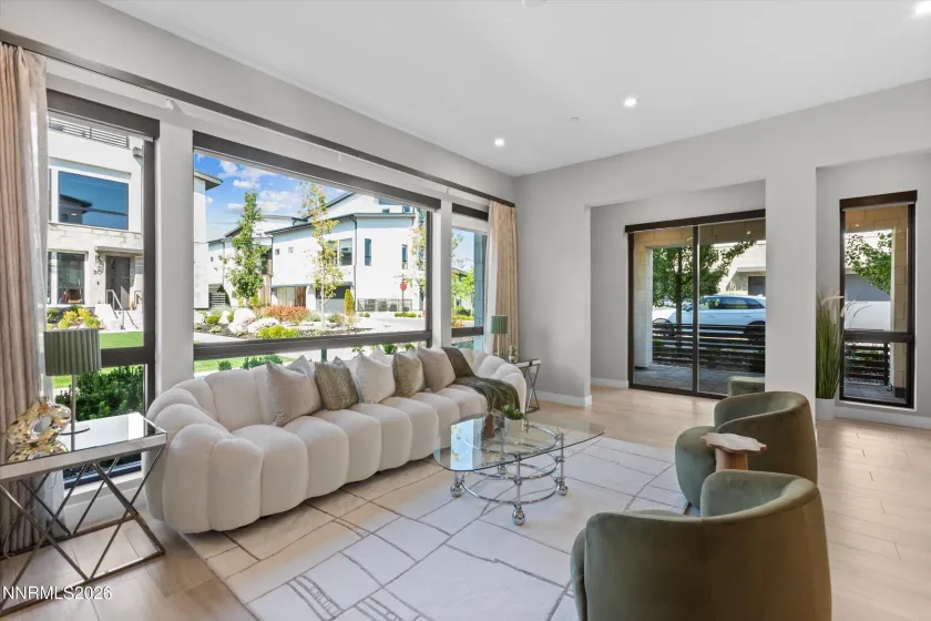 Living area West Facing Electric shades on window. Sliding door to patio shared w/ dual primary suite.