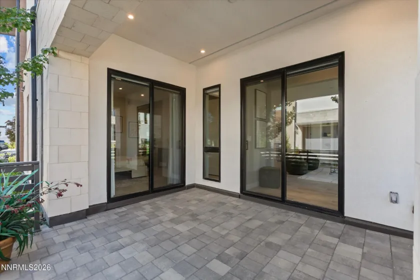 Patio with doors to dual primary and living area.