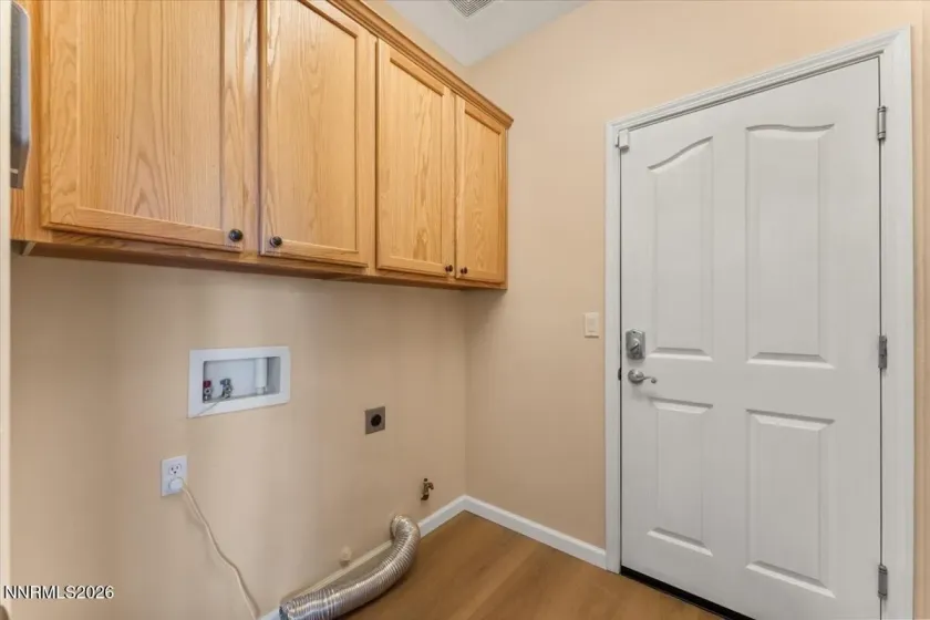 Laundry room with cabinets on both sides