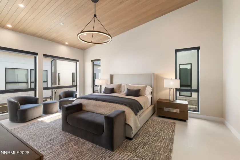 Primary Bedroom with custom wood ceiling treatment and Restoration Hardware chandelier.